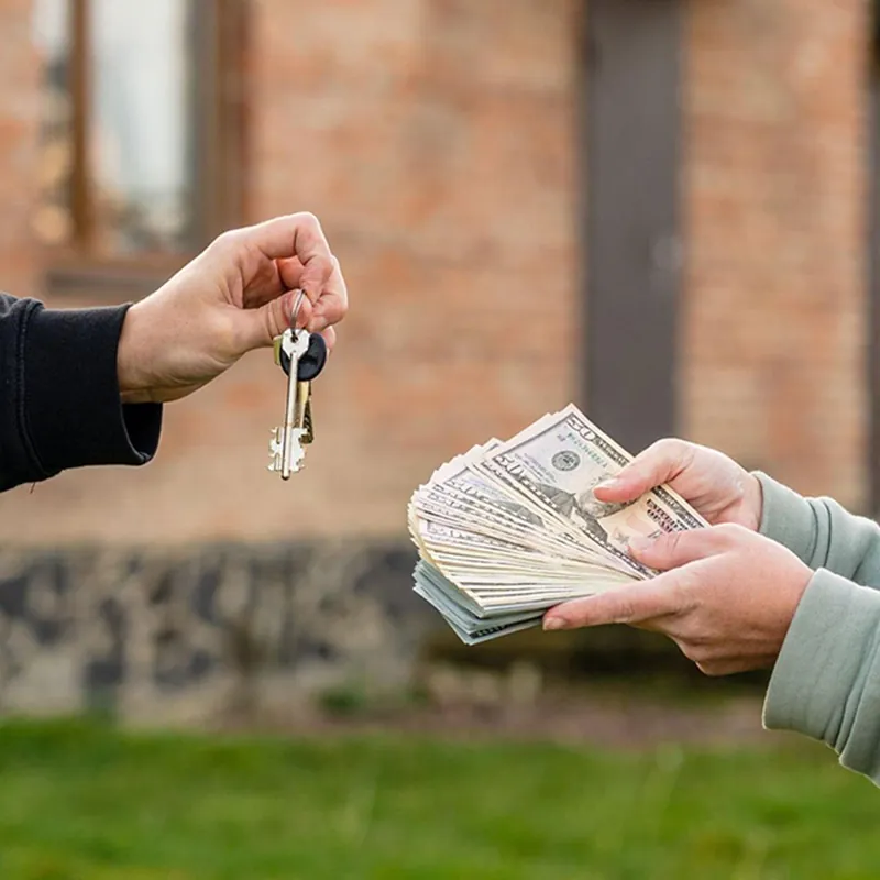 House keys handed over in exchange for cash, illustrating cash-out property financing